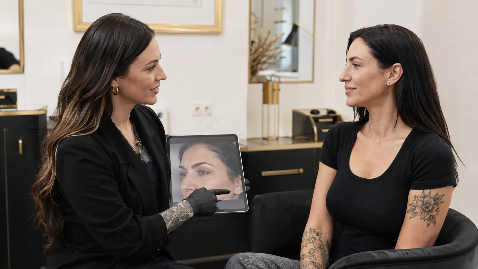 Body art artist and client reviewing a fully healed result at a follow-up consultation